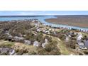 Stunning aerial view showcases the community, with river access and lush landscaping at 263 Sea Cloud Cir, Edisto Island, SC 29438