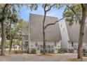 A lovely two-story condo, accented by mature trees, offers a serene and picturesque view at 263 Sea Cloud Cir, Edisto Island, SC 29438