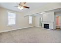 Inviting living room with neutral walls, carpet, a ceiling fan, and a decorative fireplace at 2641 Woodlawn Ave, North Charleston, SC 29405