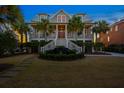 Charming coastal home with a welcoming front porch, beautiful landscaping and a green lawn at 2722 Crooked Stick Ln, Mount Pleasant, SC 29466