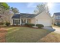 Charming single-story home with a well-manicured lawn and an attached two-car garage at 3438 Farmers Market Dr, Charleston, SC 29414
