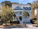 Charming two-story home with a porch, balcony, and a two car garage at 4108 Whiting St, Mount Pleasant, SC 29466