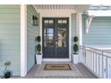 Elegant front entrance featuring double doors, side columns, and a charming 'Hello' welcome mat at 4108 Whiting St, Mount Pleasant, SC 29466