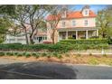 A spacious home with a charming porch and a two-car garage surrounded by lush landscaping at 42 Sowell St, Mount Pleasant, SC 29464
