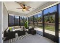 Cozy screened porch with comfortable seating, ceiling fan, and scenic backyard views for relaxed enjoyment at 422 Switchgrass Dr, Summerville, SC 29486