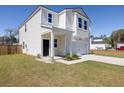 Attractive two-story home featuring a covered porch, attached garage and landscaped front yard at 455 Minim St, Charleston, SC 29414