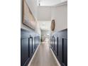 Stylish hallway featuring wood-look floors, decorative wainscoting, and elegant decor at 455 Minim St, Charleston, SC 29414