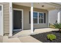 Inviting home exterior featuring a covered porch, neutral siding, and landscaped front yard at 491 Fox Sparrow Ct, Summerville, SC 29486