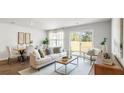Bright living room with hardwood floors and a patio door provides seamless indoor/outdoor living at 508 Golden Embers Way, Summerville, SC 29486