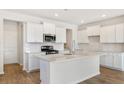 Bright and modern kitchen with white cabinets, stainless steel appliances, and a large center island at 509 Verdi Dr, Summerville, SC 29486