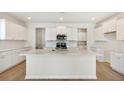 Bright, open kitchen featuring white cabinets, a center island, and modern stainless steel appliances at 509 Verdi Dr, Summerville, SC 29486