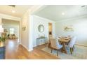 Bright dining room with hardwood floors, a wooden table, and stylish decor at 509 Yukon Ct, Lincolnville, SC 29485