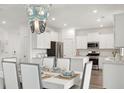 Dining area featuring a modern chandelier, a table set for six, and stainless steel appliances at 531 Verdi Dr, Summerville, SC 29486