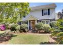 Two-story home with brick accents, manicured bushes, and a classic covered front entrance at 649 Pawley Rd, Mount Pleasant, SC 29464
