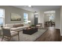 Bright living room with hardwood floors and natural light, seamlessly connected to the dining area at 7120 Sweetgrass Blvd, Hanahan, SC 29410