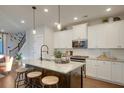 Kitchen island with granite countertops, a dark base, and seating for three at 713 Rumbling Leaf Ln, Summerville, SC 29486