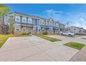 A row of well-maintained townhomes featuring individual driveways for convenient parking at 7803 Park Gate Dr, Charleston, SC 29418