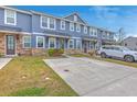 Inviting exterior view of townhomes with stone accents and ample parking space at 7803 Park Gate Dr, Charleston, SC 29418