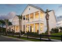 Beautiful home exterior with double porches, lush landscaping, and inviting curb appeal at twilight at 792 Clay Field Trl, Summerville, SC 29485