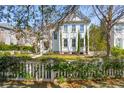 Charming two-story home featuring a landscaped yard and a classic white picket fence at 873 Tupelo Bay Dr, Mount Pleasant, SC 29464