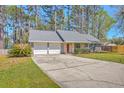 Charming single-story home with a well-kept lawn, mature trees, and convenient two-car garage at 891 Wynford Ct, Mount Pleasant, SC 29464