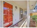 Inviting front porch featuring a bright red door, cozy seating, and charming exterior details at 891 Wynford Ct, Mount Pleasant, SC 29464