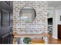 Welcoming entryway featuring a decorative mirror, stylish console table, and accent wall with unique brick design at 101 Plantation Dr, Summerville, SC 29485