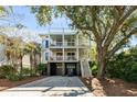 Multi-level home featuring double porches, a two car garage, and a golf cart in the driveway at 108 Carolina Blvd, Isle of Palms, SC 29451