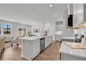 Open-concept kitchen with a large island, sleek appliances, and an adjacent dining area at 110 Brown Swiss Cir, Summerville, SC 29483