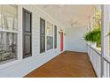 Relaxing front porch with ceiling fans, wood floors, and views of the surrounding trees at 1100 Sea Island Crossing Ln, Mount Pleasant, SC 29464