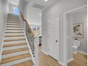 Well-lit staircase with wood treads and iron railing, leading to the upper level at 112 Brown Swiss Cir, Summerville, SC 29483