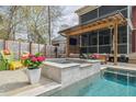 Backyard pool and patio with a covered outdoor seating and entertainment area at 1149 Lands End Dr, Hanahan, SC 29410