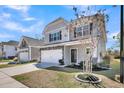 Charming two-story home with stone accents, a two-car garage, and a well-manicured front yard at 1173 Triple Crown Court, Mount Pleasant, SC 29429