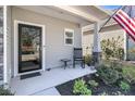 Inviting front porch with a rocking chair and decorative plants, perfect for relaxing at 1173 Triple Crown Court, Mount Pleasant, SC 29429