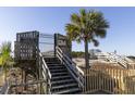 Private pier access featuring wooden stairs, gate, and a sandy path, enhancing beachfront living at 1300 Ocean Blvd # 139, Isle of Palms, SC 29451