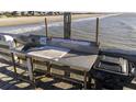 Fishing station on pier featuring a sink, cutting board, and utensil holders with a black trashcan on a sunny day at 1300 Ocean Blvd # 139, Isle of Palms, SC 29451