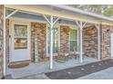 Inviting covered front porch featuring a seating area with comfortable chairs and decorative plants at 131 Kennington Dr, Goose Creek, SC 29445