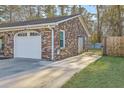 Attached garage with a white door and ample driveway space, complementing the brick exterior at 131 Kennington Dr, Goose Creek, SC 29445