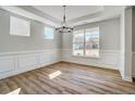 Bright dining room featuring wood floors, large windows, and elegant chandelier at 134 Palfrey Dr, Ridgeville, SC 29472