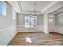 Elegant dining room with decorative trim, chandelier and plentiful natural light at 134 Palfrey Dr, Ridgeville, SC 29472