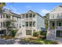 Charming two-story home featuring double front porches, stairs and covered parking at 1450 Eutaw Battalion Dr, Charleston, SC 29412