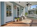Relax on this front porch with outdoor furniture, ceiling fans, and 'Home Sweet Home' doormat at 1450 Eutaw Battalion Dr, Charleston, SC 29412