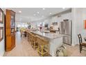Open-concept kitchen features a large island, stainless steel appliances, and an open flow to the dining area at 178 Garden Gate Way, Summerville, SC 29486