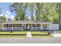Charming brick and siding home featuring a quaint front porch and well-maintained landscaping at 1861 Jaywood Cir, Charleston, SC 29407