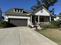 A single-Gathering house with a two-car garage and a concrete driveway is surrounded by landscaping at 2009 Utsey St, Johns Island, SC 29455