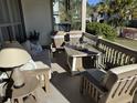 Covered porch area featuring comfortable seating and a gas-burning fire table at 2009 Utsey St, Johns Island, SC 29455