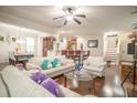 Inviting living room featuring hardwood floors, ample seating, modern decor, and view to kitchen and stairway at 2049 Maybelles Ln, Charleston, SC 29414