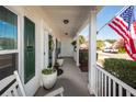 Spacious covered porch with rocking chairs and a view of the landscaped front yard at 2052 Bancroft Ln, Mount Pleasant, SC 29466