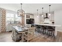 Open concept kitchen featuring stainless steel appliances, a large island, and adjacent dining area at 2165 Annie Laura Ln, Mount Pleasant, SC 29466