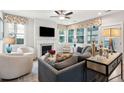Bright living room with ample natural light, fireplace, plush seating, and stylish decor at 2165 Annie Laura Ln, Mount Pleasant, SC 29466